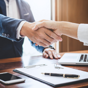 Two shaking hands in a business office.