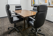 Meeting room table with four chairs.