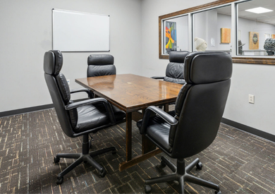 Meeting room table with four chairs.