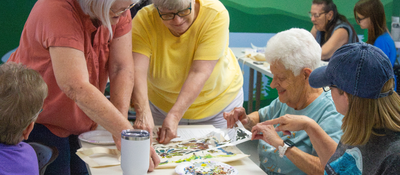 Adults working on a craft.